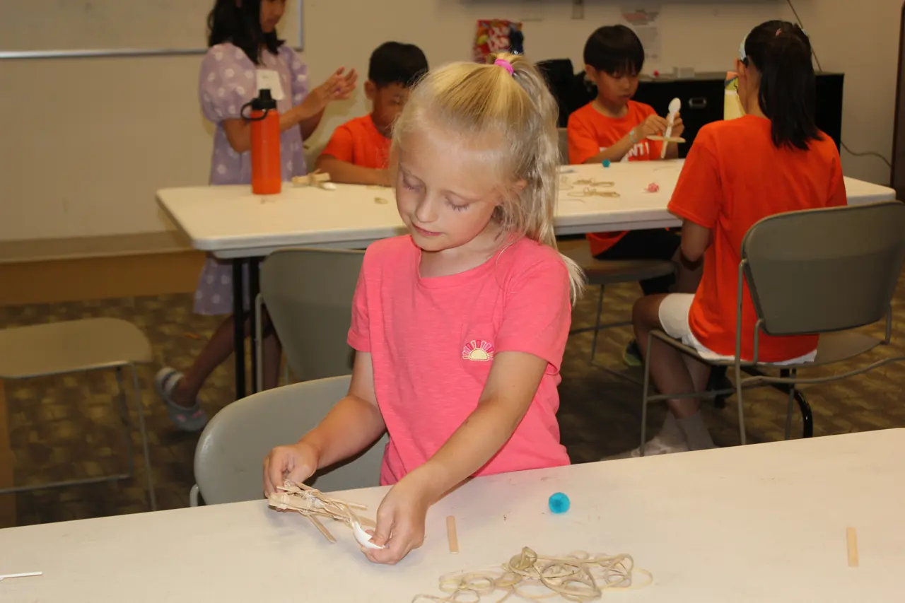 Student experimenting with hands-on materials at a workshop